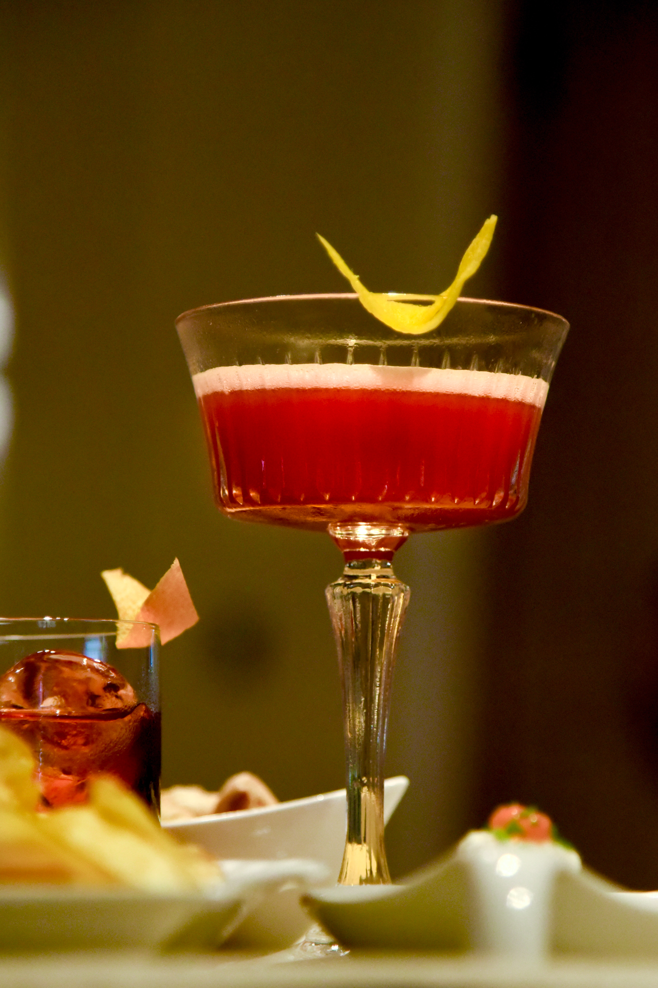 Cocktail rosso con twist di agrume servito nella lounge di Corallia Gourmet